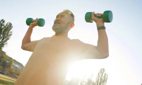 gentlemen lifting hand weights outdoors