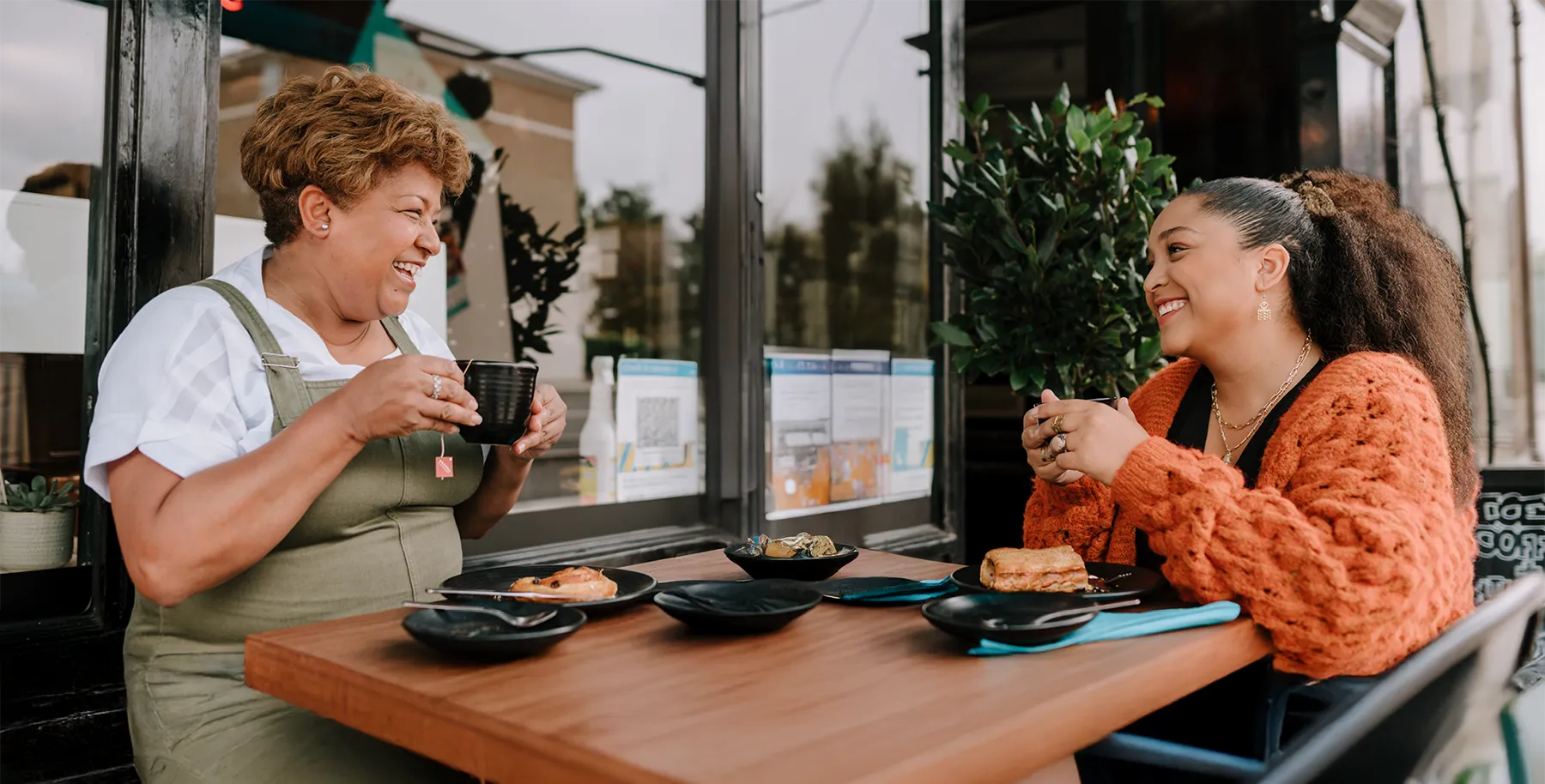 Two people enjoying a meal at an outdoor cafe