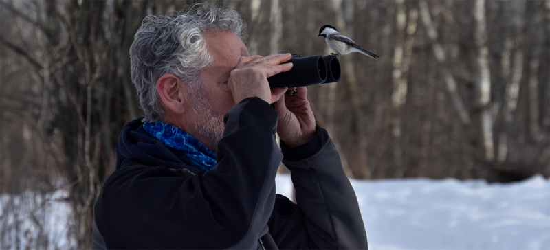 older gentleman with binoculars in winter outdoors