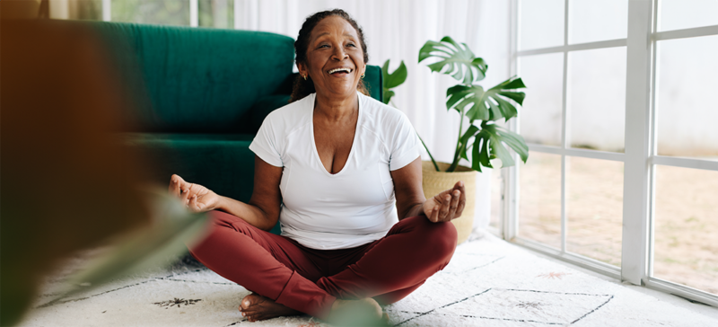 older woman meditating with a smaile