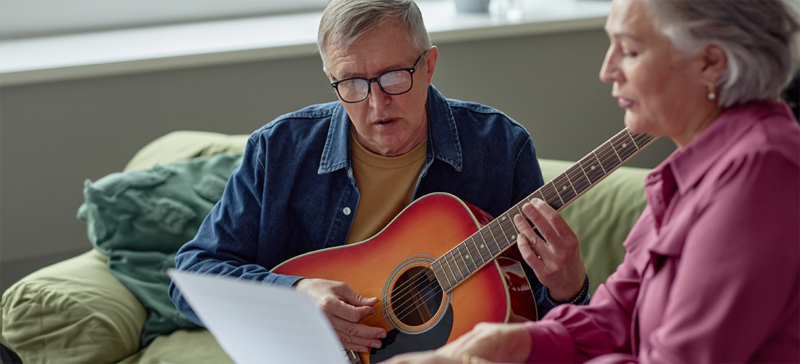 older gentlemen learning to play guitar