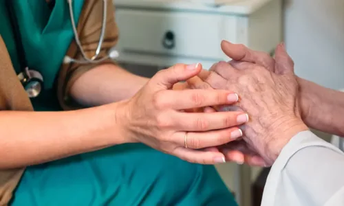 two sets of hands, one belonging to an older adult