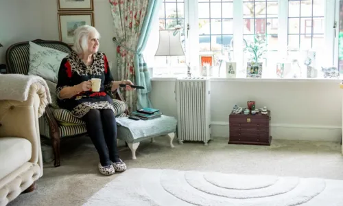 Older adult woman seated in a room